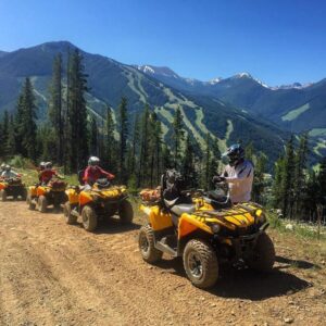 A group of ATV in the mountains on a sunny day at Toby Creek Adventures